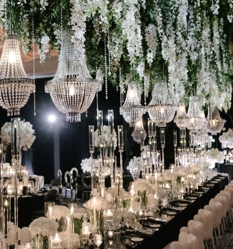 Luxury wedding reception with hanging wisteria and greenery chandeliers