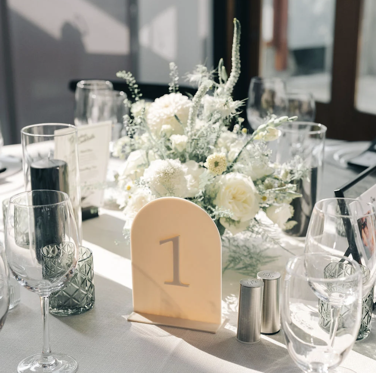 Wedding table number sign with white floral centerpiece