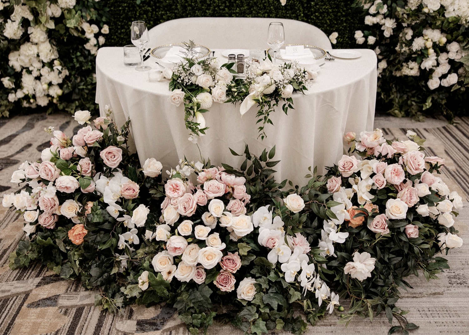 Romantic sweetheart table with blush and white florals and greenery