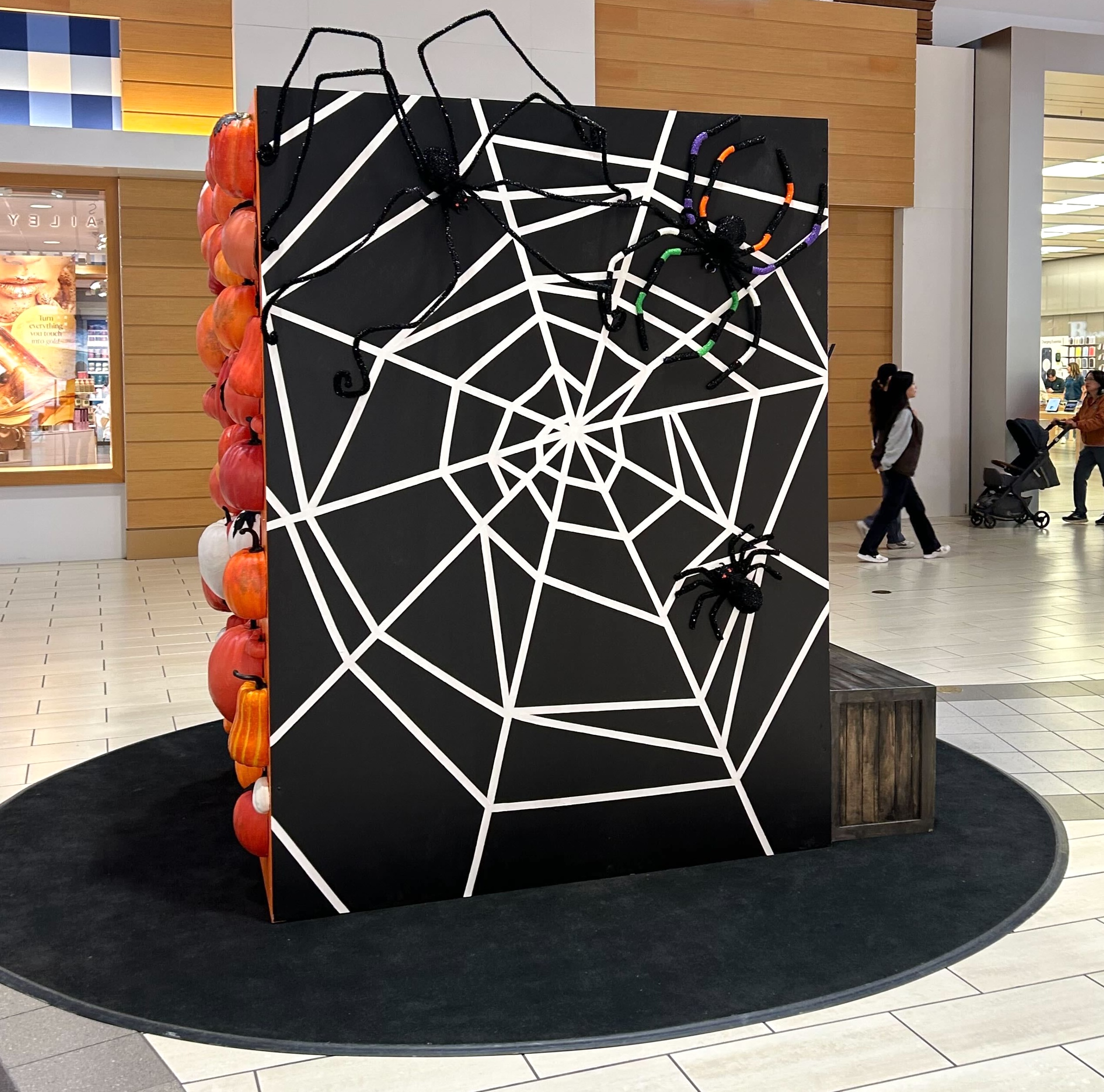 Spider web themed Halloween backdrop display in shopping mall
