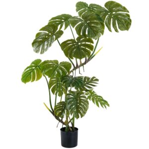 Artificial monstera plant with large split green leaves in a black round pot on a white background.