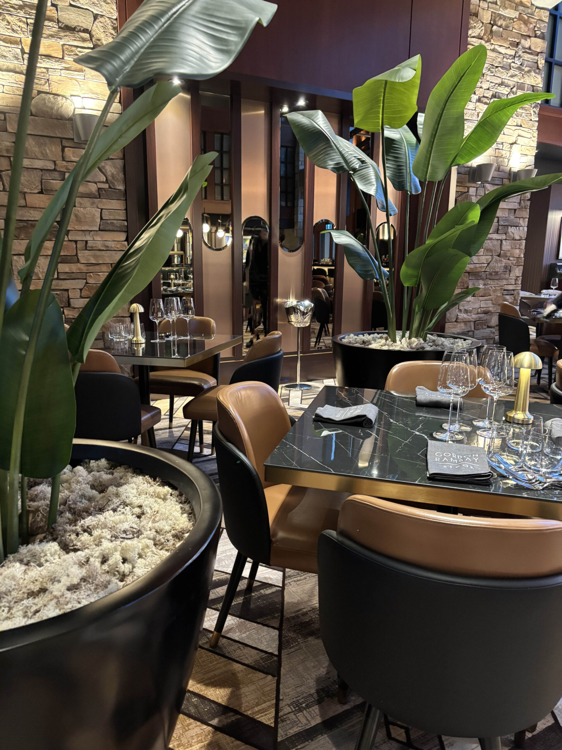 Artificial potted palm placed beside restaurant seating