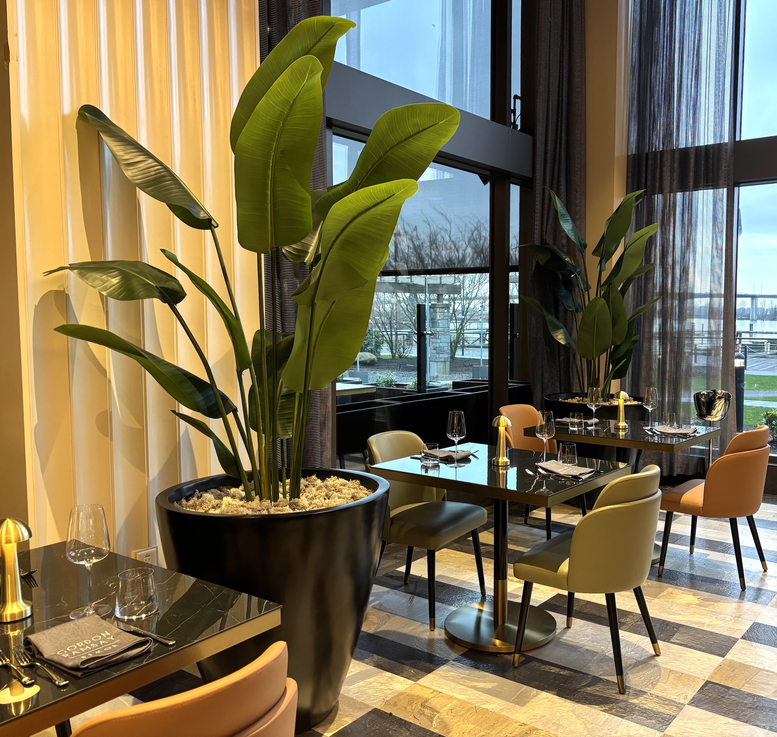 Faux potted palm placed near restaurant window seating