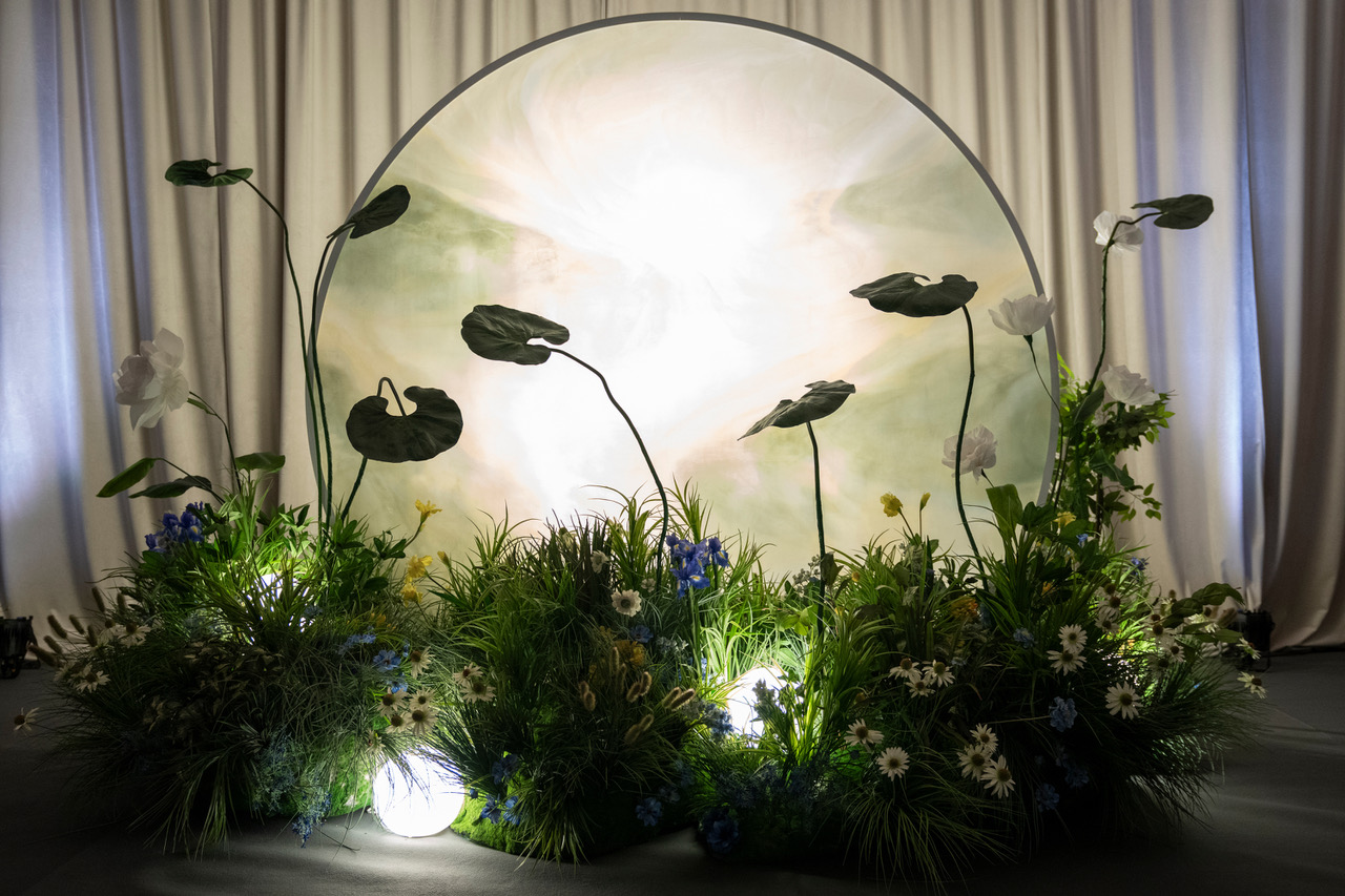 Garden meadow lounge backdrop with greenery and floral arrangements