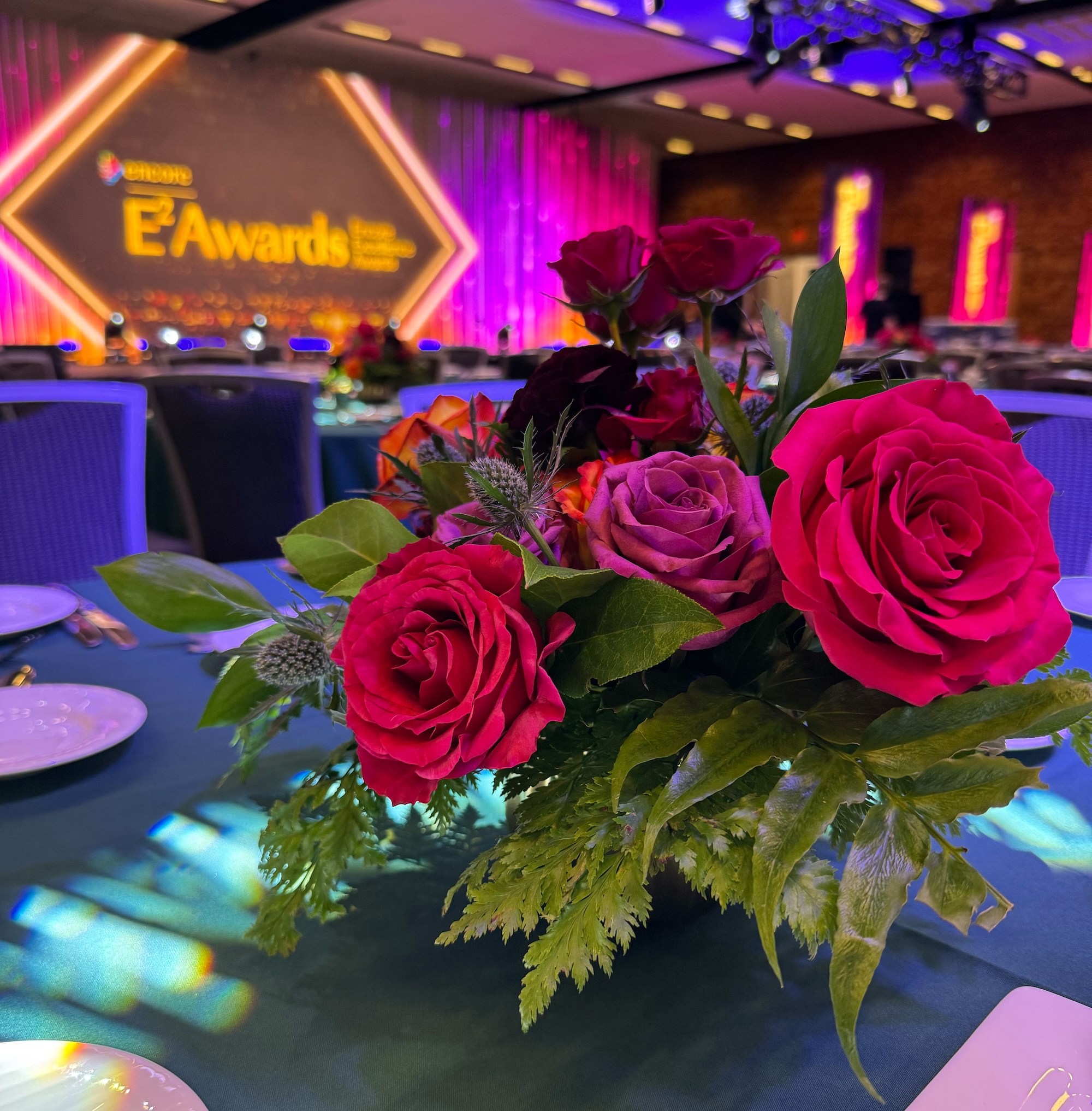 Red rose floral centrepiece on table at awards gala event