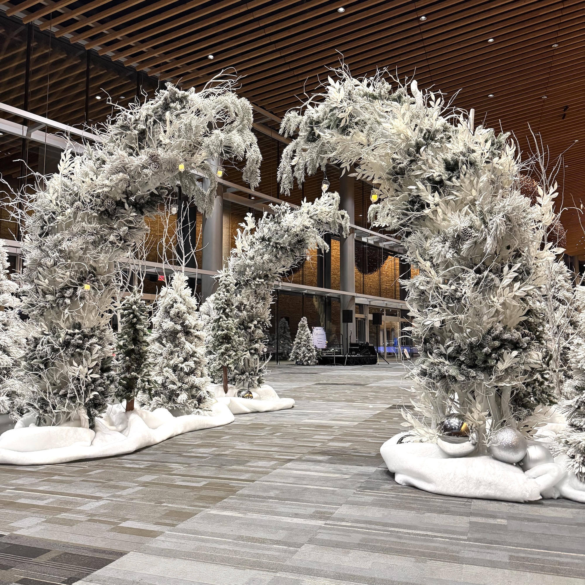 Winter wonderland forest entry arches with snow-covered branches for event entrance